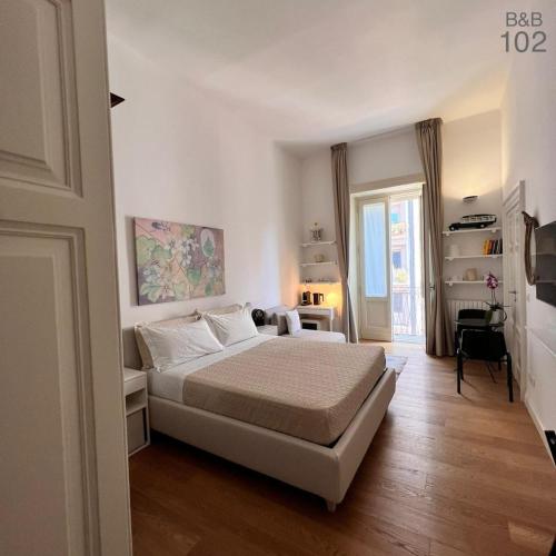 1 dormitorio con cama y sofá en B&B 102, en Taranto