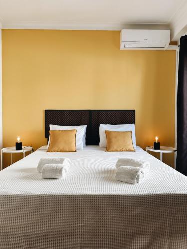 a bedroom with a large bed with two pillows at Alvor Apartment in Alvor