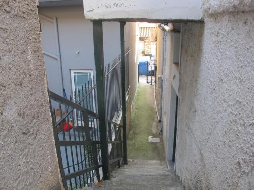 an alleyway between two buildings with a gate at One Home ~ Fits All in Mouzákion