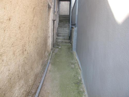 an alley with stairs in an alley way with a building at One Home ~ Fits All in Mouzákion