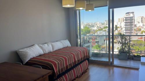 a bedroom with a bed and a view of a city at Sissi Apart in Buenos Aires