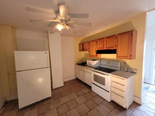 a kitchen with white appliances and a ceiling fan at Downtown Norfolk private room D1 in Norfolk