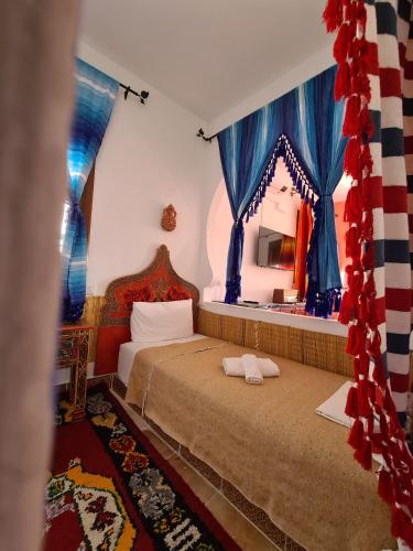 a bedroom with a bed with two pillows on it at Casa Blue Star in Chefchaouene