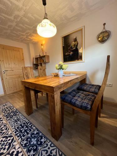 a dining room with a wooden table and chairs at Ferienhaus „Casa Lore“ in Frankenheim