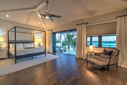 a bedroom with a bed and a couch and a fan at Bayside Paradise Mansion in Clearwater Beach