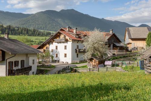 a village with houses and mountains in the background at Schusterhof - Urlaub auf dem Bauernhof in Novale