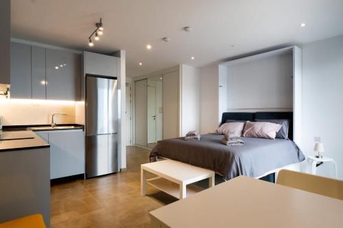 a kitchen and a bedroom with a bed in a room at E1 Rock View Studio9 -Hosted by Sweetstay in Gibraltar