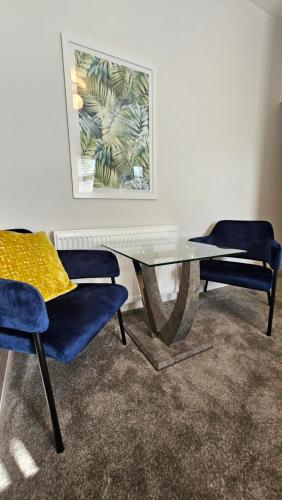 a table with two chairs and a picture on the wall at ABBEY HOTEL in Stafford