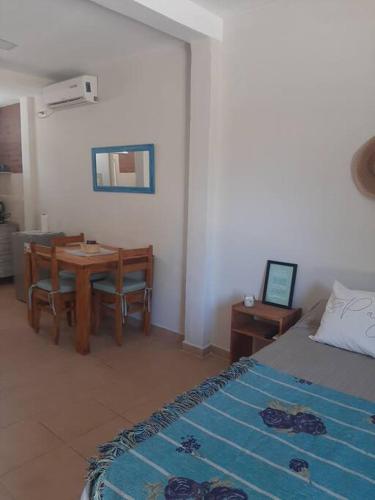 a bedroom with a table and a bed and a dining room at Temporario Necochea 2 corrientes in Corrientes