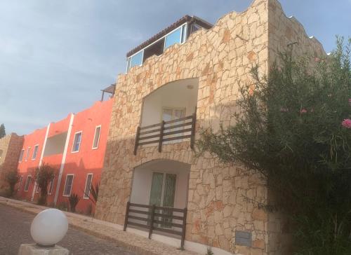 a brick building with a balcony on the side of it at KatlantiK Estoril Deluxe in Sal Rei