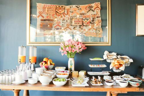 a table with a bunch of food on it at Palacio Manco Capac by Ananay Hotels in Cusco