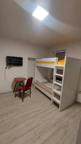 a room with two bunk beds and a table at Restoran Ruža in Jablanica
