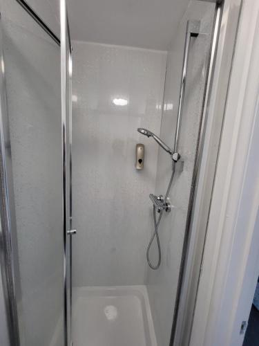 a bathroom with a shower with a glass door at Nottingham Forest Rd, Short Stays in Nottingham