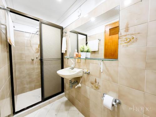 a bathroom with a sink and a shower at Aparta Hotel Downtown Guatapé in Guatapé