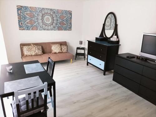 a living room with a table and a couch at Kleine Ferienwohnung mit Terrasse am Waldrand in Schönau