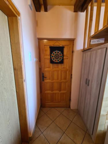 a hallway with a wooden door in a house at Vikendica Nina in Mitrovac