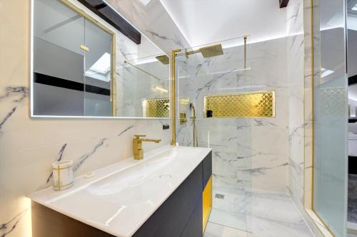 a bathroom with a sink and a mirror at Swish Luxury Holiday Apartments in Blackpool