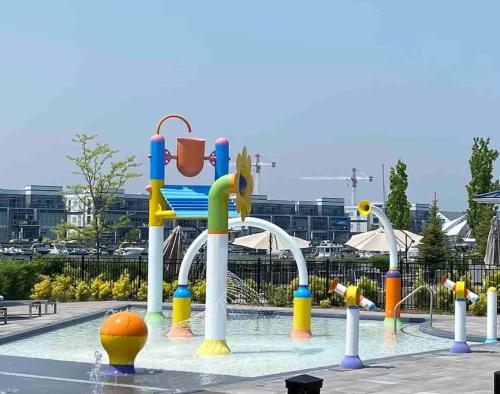 a pool with a water park with a playground at 2 bedroom 2 bath Aquarius, Friday Harbour, Innisfil, Barrie in Innisfil