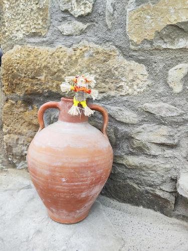 a vase with flowers in it next to a stone wall at Casa Min in Lasieso