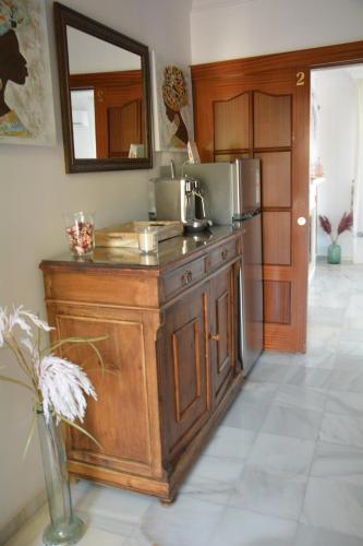 a kitchen with a wooden island with a microwave at Casa Beatriz in Rincón de la Victoria
