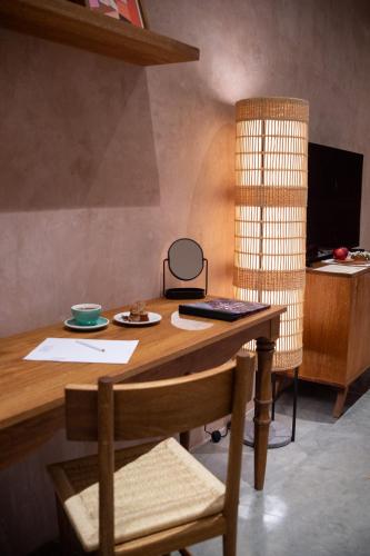 a wooden desk with a chair and a laptop on it at Casa Antonieta in Oaxaca City