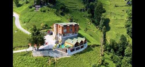 an aerial view of a house on a hill at Peruma otel bungalov in Çamlıhemşin