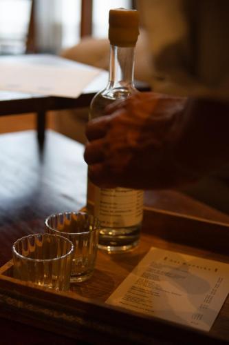 a bottle of whiskey and two glasses on a table at Casa Antonieta in Oaxaca City