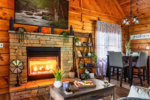 a living room with a fireplace in a log cabin at Couples retreat *location*hot tub*fire pit* in Pigeon Forge