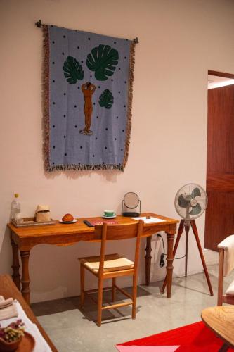 a wooden table and chair in a room at Casa Antonieta in Oaxaca City