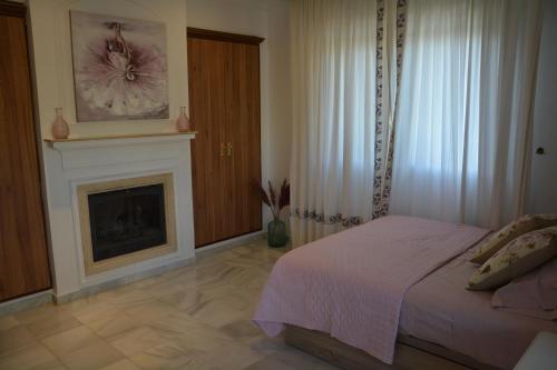 a bedroom with a bed and a fireplace at Casa Beatriz V in Rincón de la Victoria