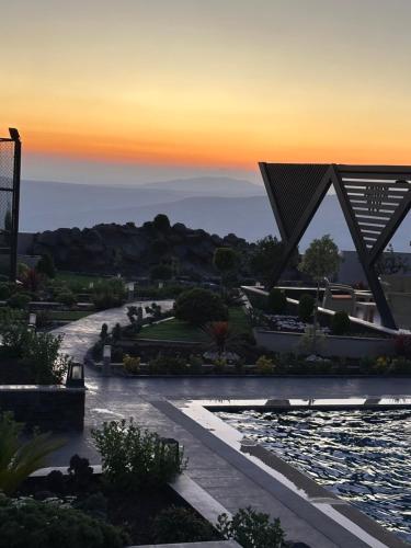 a view of a park at sunset with a fountain at Kinda vip in Al Mashāriqah