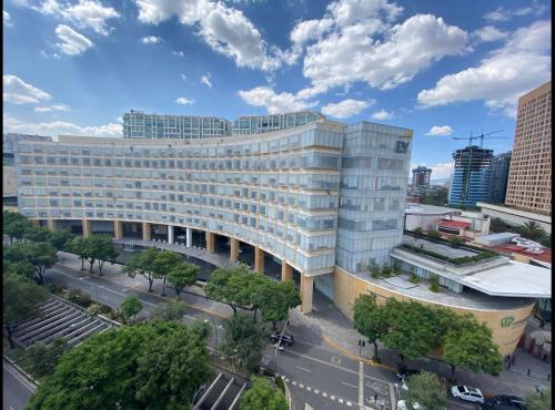 a large white building in a city with a street at comfortable and cool suite in Polanco with GYM in Mexico City