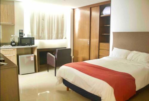 a hotel room with a bed and a kitchen at comfortable and cool suite in Polanco with GYM in Mexico City