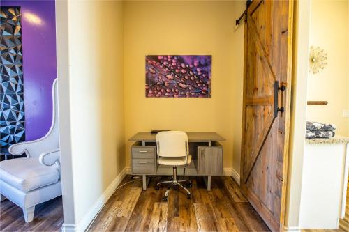 an office with a desk and a chair and a painting at 3400 SqFt House W/40Ft Heated Pool/Spa- Strip View in Henderson