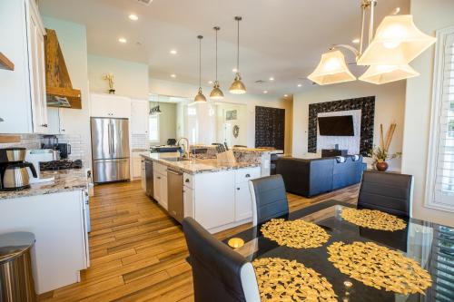 a kitchen and living room with a table and a kitchen and a living room at 3400 SqFt House W/40Ft Heated Pool/Spa- Strip View in Henderson