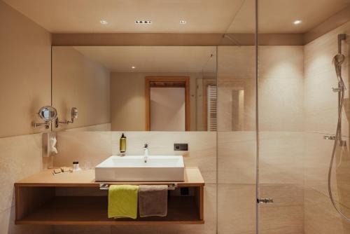 a bathroom with a sink and a shower at Hotel Grien in Ortisei