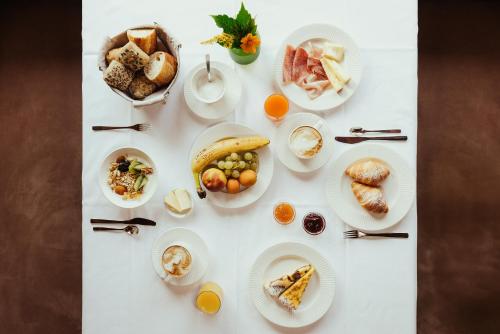 a white table with plates of food on it at Hotel Grien in Ortisei