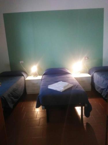 a room with two beds with lights on them at Appartamento 4 - NEW in Comezzano