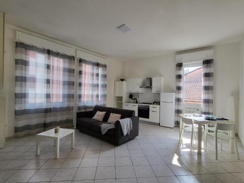 a living room with a couch and a table at White Home Forli Centro in Forlì