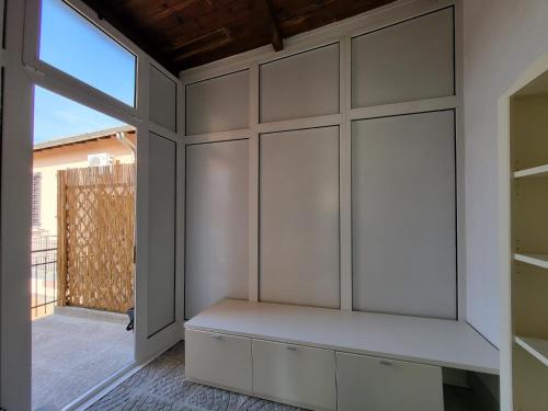 a room with white cabinets and a window at White Home Forli Centro in Forlì