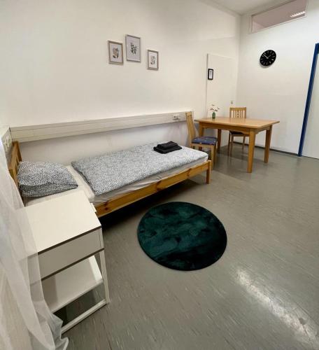 1 dormitorio con 1 cama y 1 mesa en una habitación en Das Quartier, en Himberg