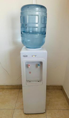 a blue bowl on top of a white refrigerator at EL NOPAL Hostal in Polonia