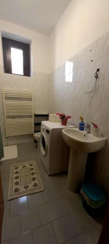 a bathroom with a toilet and a sink at Appartamento 8 in Comezzano