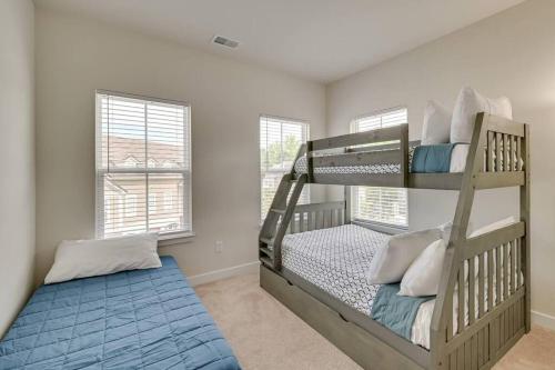 a bedroom with two bunk beds and a blue rug at Barefoot Resort & Golf. Near Barefoot Landing. in North Myrtle Beach
