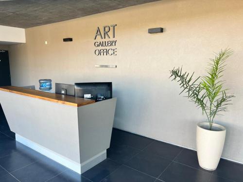 an art gallery office with a potted plant at Art Gallery Pilar in Pilar