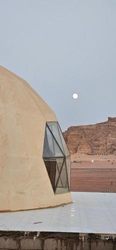 a building with a window on the side of it at Darien Luxury Camp in Wadi Rum