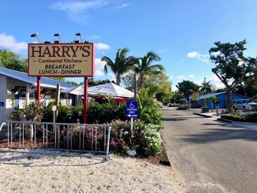 a sign for a harrys restaurant on a street at 7th Heaven condo in Longboat Key