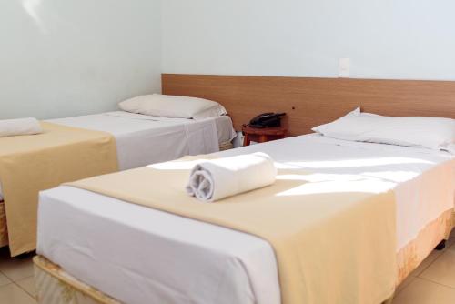 a room with two beds with white sheets at Pompeu Rio Hotel in Rio de Janeiro