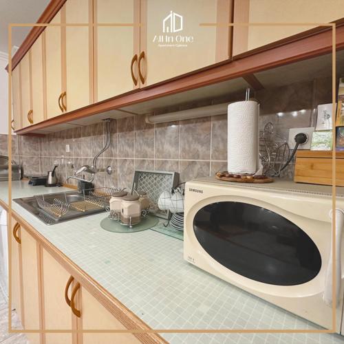 a kitchen with a microwave on a counter at ALL IN ONE APARTMENT GJAKOVA - Self Check In in Gjakove