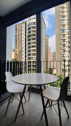 a table and two chairs sitting on a balcony at Belíssimo Studio Perdizes in São Paulo